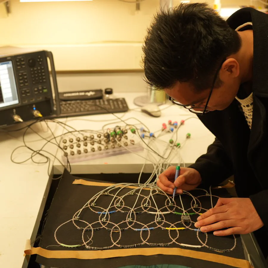 Lab member tuning a flexible multi-channel receive array on the bench